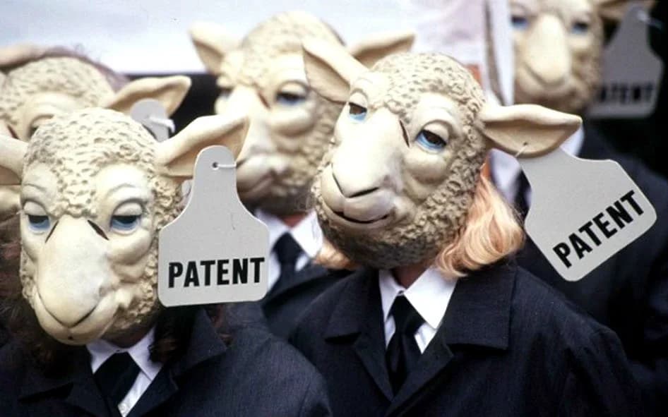 Protesters wearing sheep masks labeled 'PATENT' in a satirical depiction of conformity
